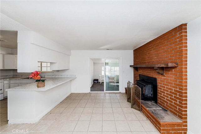 kitchen featuring white cabinets, light tile patterned floors, and light countertops