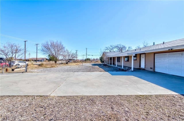 view of yard featuring driveway and an attached garage