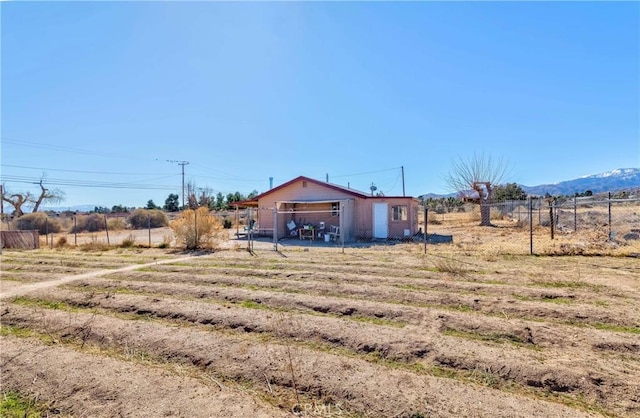 view of yard featuring fence and a rural view