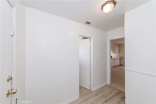 hall with visible vents and light wood finished floors