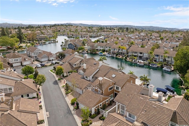 drone / aerial view featuring a water view and a residential view