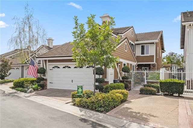 view of front of property with stucco siding, an attached garage, stone siding, driveway, and a tiled roof