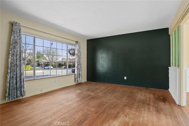 spare room featuring wood finished floors