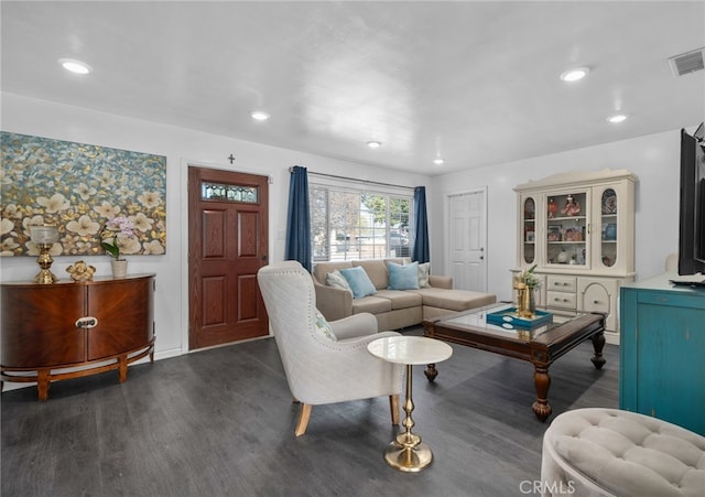 living area with wood finished floors, visible vents, and recessed lighting