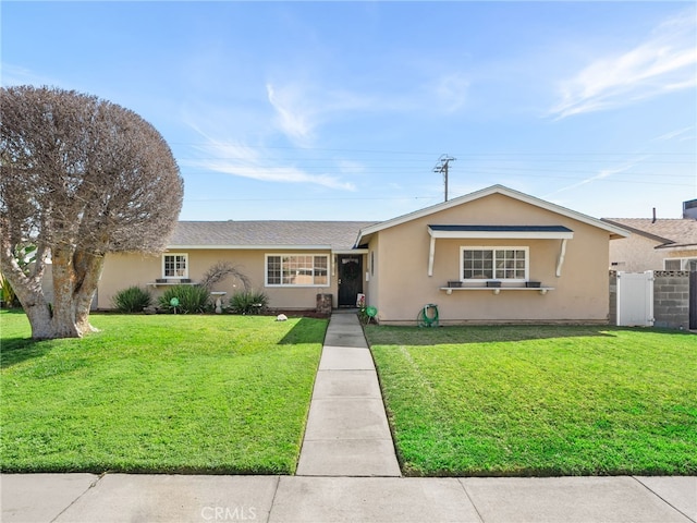 ranch-style home with fence, a front lawn, and stucco siding