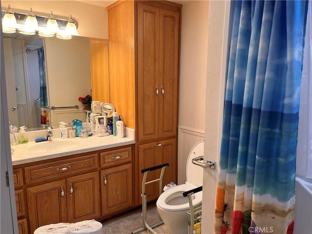 bathroom featuring curtained shower, tile patterned flooring, vanity, and toilet