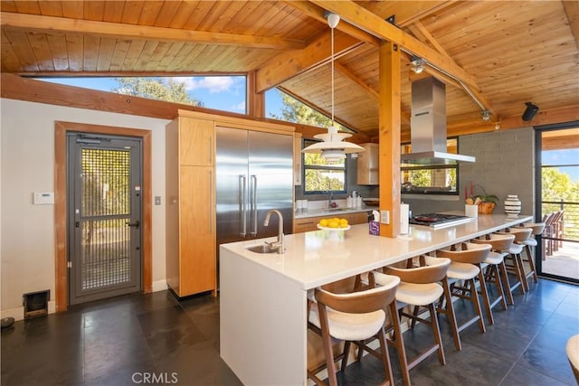 kitchen featuring vaulted ceiling with beams, wooden ceiling, island exhaust hood, and a sink