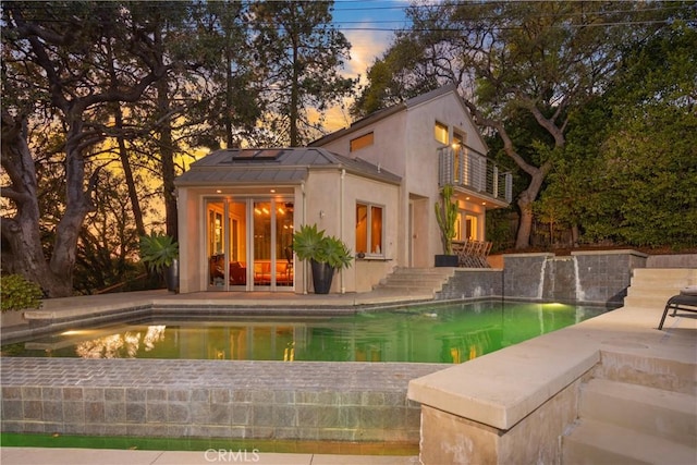 pool with a patio area, a storage structure, and an outdoor structure