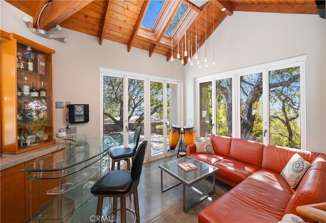 sunroom / solarium featuring vaulted ceiling with skylight and wood ceiling