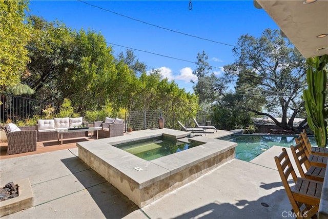 outdoor pool with an in ground hot tub, a patio area, fence, and an outdoor living space