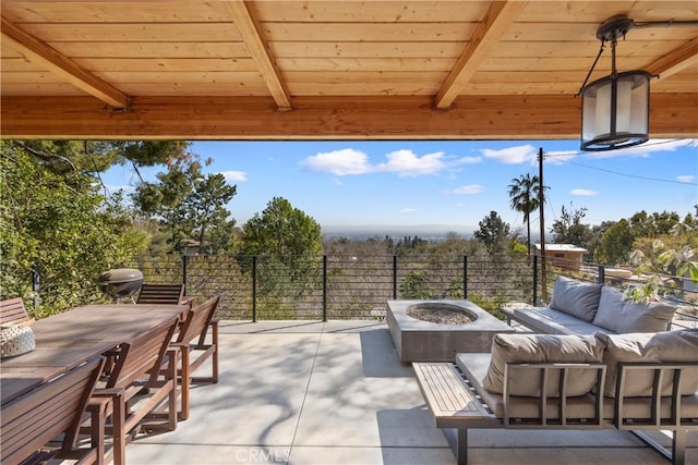 view of patio / terrace featuring outdoor dining area and an outdoor living space with a fire pit