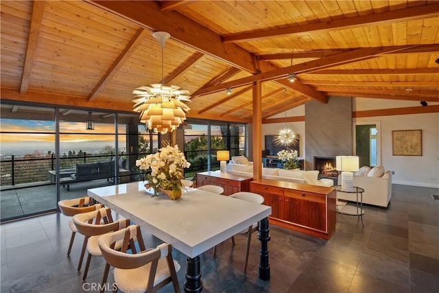 dining room featuring vaulted ceiling with beams, a large fireplace, wooden ceiling, and a chandelier