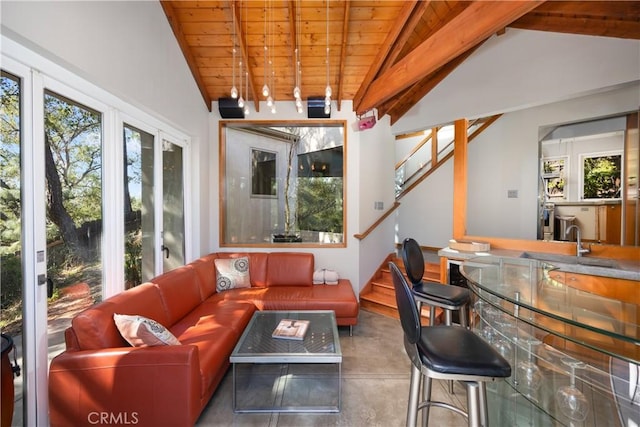 living room featuring concrete flooring, wooden ceiling, stairway, and lofted ceiling with beams