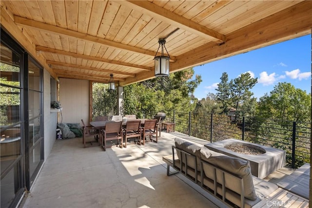 view of patio featuring an outdoor fire pit, outdoor dining area, and area for grilling