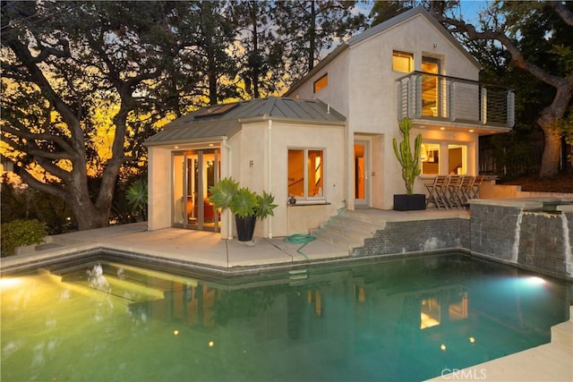 outdoor pool featuring a patio area and outdoor dry bar