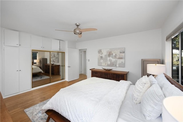 bedroom featuring ceiling fan, a closet, and wood finished floors