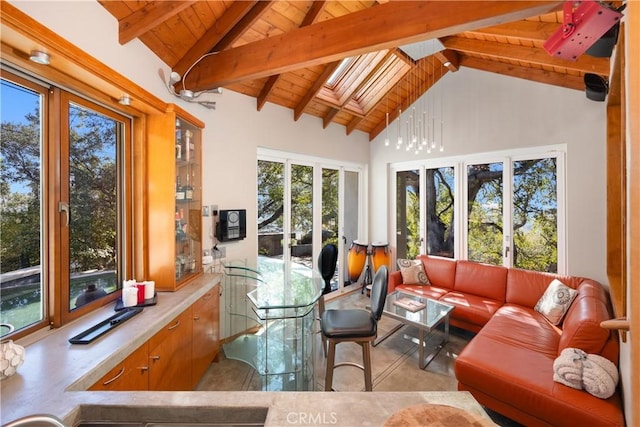 sunroom / solarium with lofted ceiling with skylight and wood ceiling