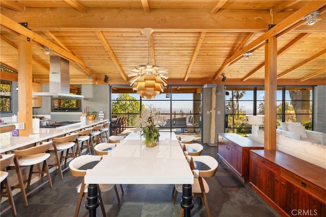 dining area featuring lofted ceiling with beams and wood ceiling