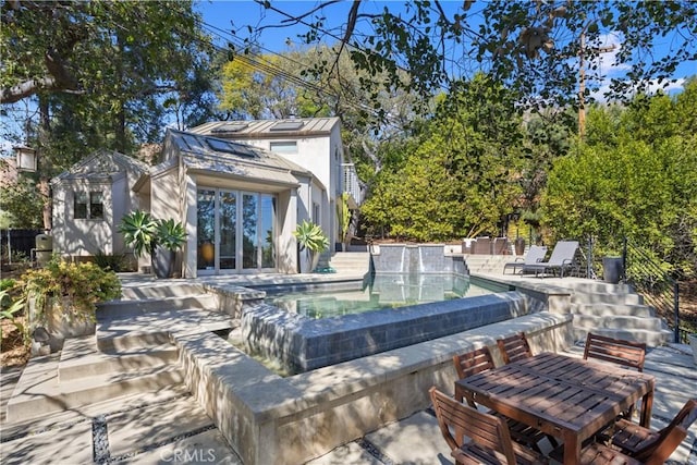 outdoor pool featuring outdoor dining space and a patio area