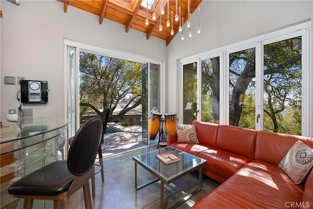 sunroom with lofted ceiling with skylight and wooden ceiling