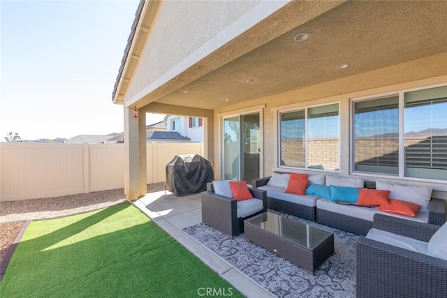 view of patio with fence, grilling area, and an outdoor hangout area