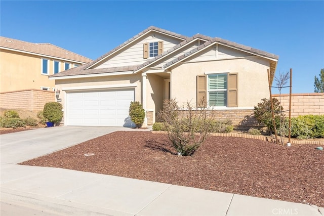 craftsman house with a garage, fence, a tile roof, driveway, and stucco siding