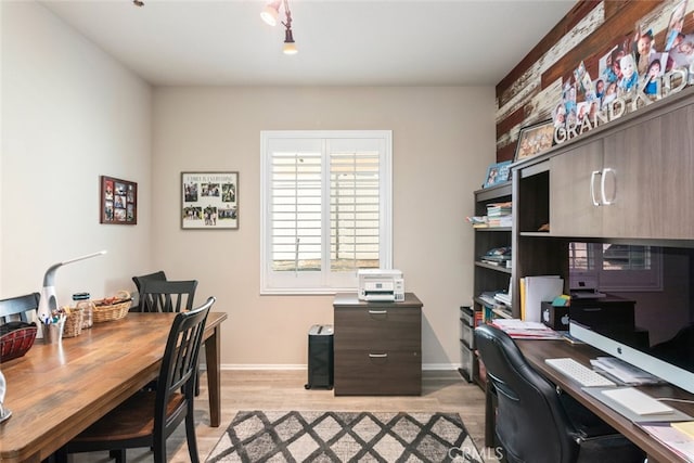 office area featuring light wood finished floors and baseboards