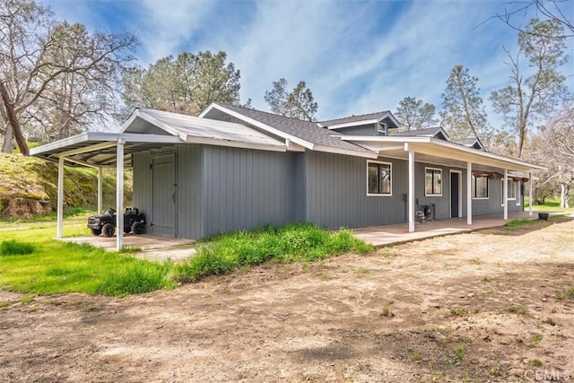 exterior space with a porch and an attached carport