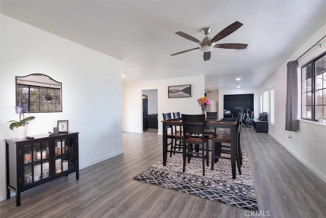 dining area featuring ceiling fan, wood finished floors, and baseboards