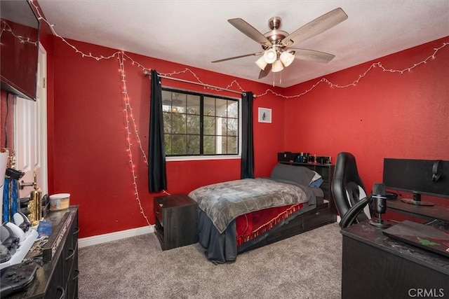 carpeted bedroom with a ceiling fan and baseboards