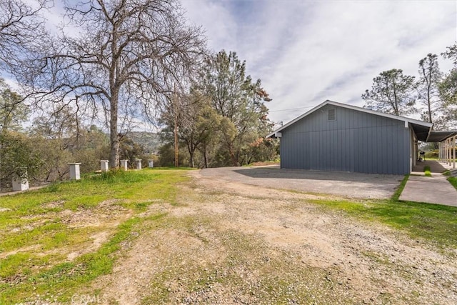 exterior space featuring driveway and a pole building