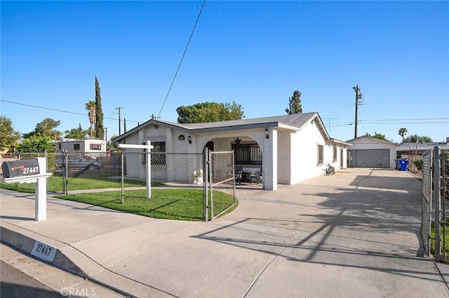 single story home with a front lawn, a fenced front yard, a gate, and stucco siding