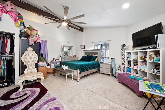 bedroom featuring lofted ceiling, a closet, ceiling fan, and carpet