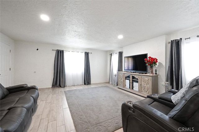 27447 Cypress St, Highland, CA 92346 - living area with a textured ceiling, light wood-style floors, baseboards, and recessed lighting