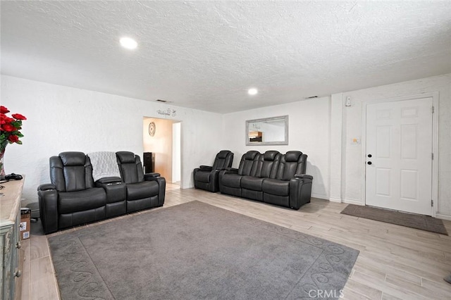 27447 Cypress St, Highland, CA 92346 - living room with a textured ceiling, light wood-style flooring, and recessed lighting