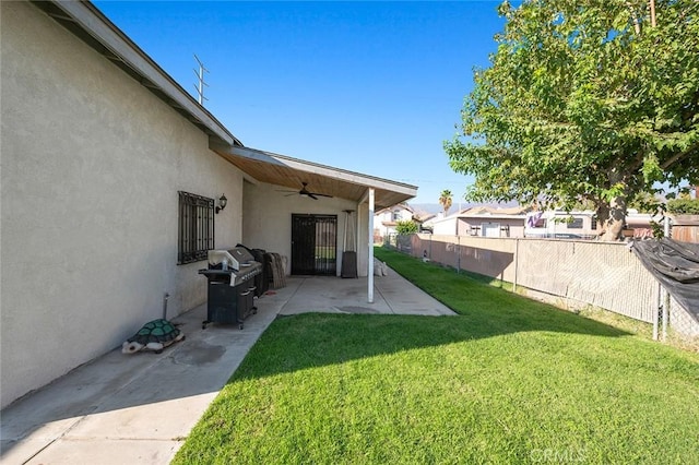 view of yard featuring ceiling fan, fence, and a patio