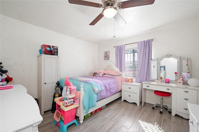 bedroom with ceiling fan and wood finish floors