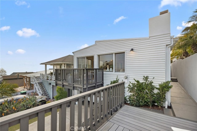 wooden terrace featuring fence