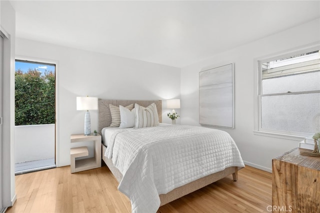 bedroom featuring light wood-style floors and baseboards