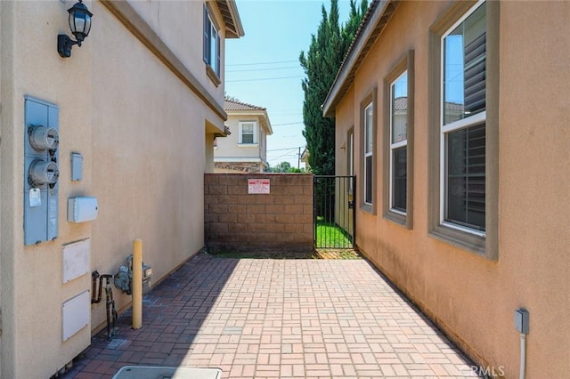 view of patio featuring fence and a gate