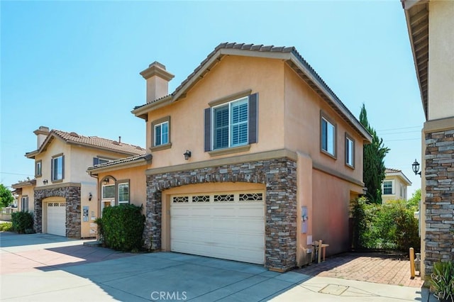 mediterranean / spanish house featuring a garage, concrete driveway, stone siding, and stucco siding