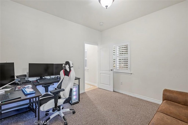 carpeted office space featuring baseboards