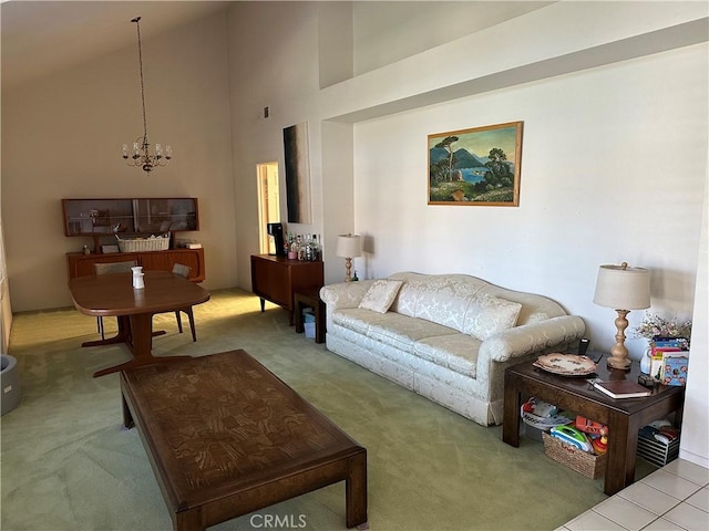 living area featuring a chandelier, carpet, and high vaulted ceiling