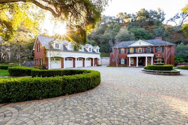 view of front facade with a garage and curved driveway