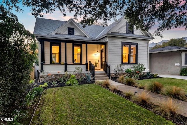 view of front facade with a yard and a porch