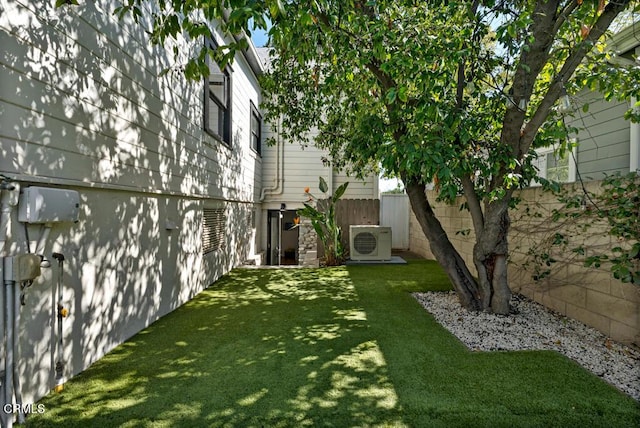 view of yard with ac unit and fence