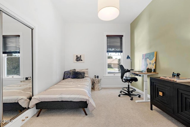 bedroom featuring baseboards and carpet flooring