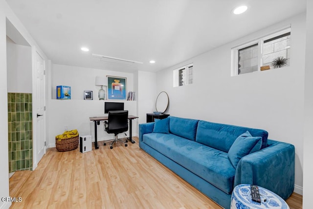 living room with baseboards, wood finished floors, and recessed lighting