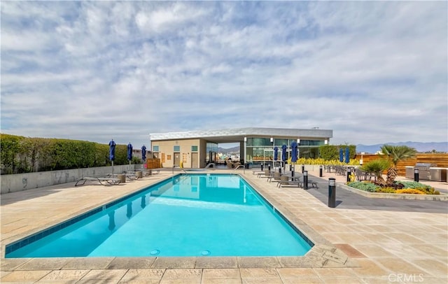 community pool featuring a patio and fence