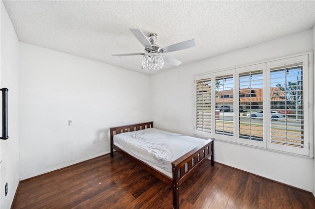 unfurnished bedroom featuring wood-type flooring, a ceiling fan, and a textured ceiling